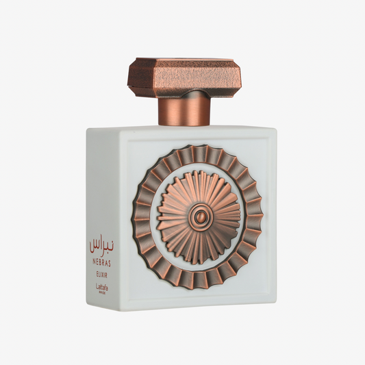 Lattafa Nebras Elixir perfume bottle in pale ivory with rose-gold geometric cap and ornate embossed circular medallion.