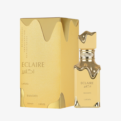 Lattafa Eclaire Banoffi Eau de Parfum in a clear glass bottle with gold-toned details and matching golden box, 100 ml.