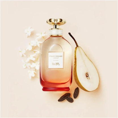 Coach Dreams Sunset women's fragrance bottle with floral gourmand notes of pear, jasmine, and tonka bean against a sunset background