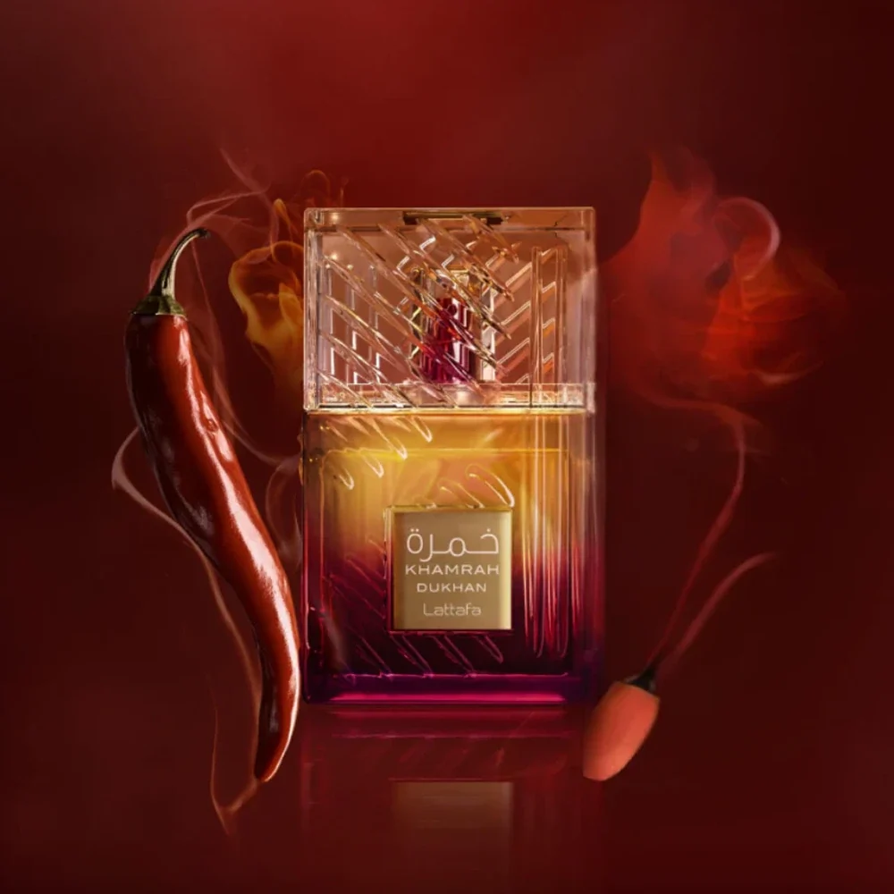 Lattafa Khamrah Dukhan eau de parfum bottle with gradient amber to deep purple glass and textured clear cap with spicy chili and burning match accents