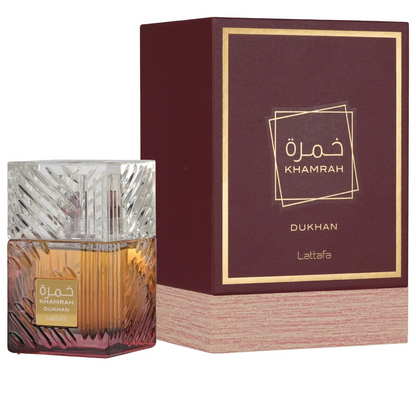 Lattafa Khamrah Dukhan eau de parfum bottle with gradient amber to purple glass and textured clear cap alongside burgundy and gold box packaging