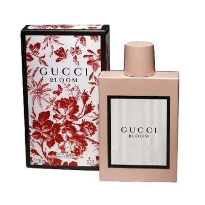 Gucci Bloom Eau De Parfum bottle with floral background representing feminine, elegant fragrance notes of jasmine, tuberose, honeysuckle, and iris
