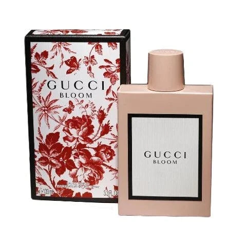 Gucci Bloom Eau De Parfum bottle with floral background representing feminine, elegant fragrance notes of jasmine, tuberose, honeysuckle, and iris
