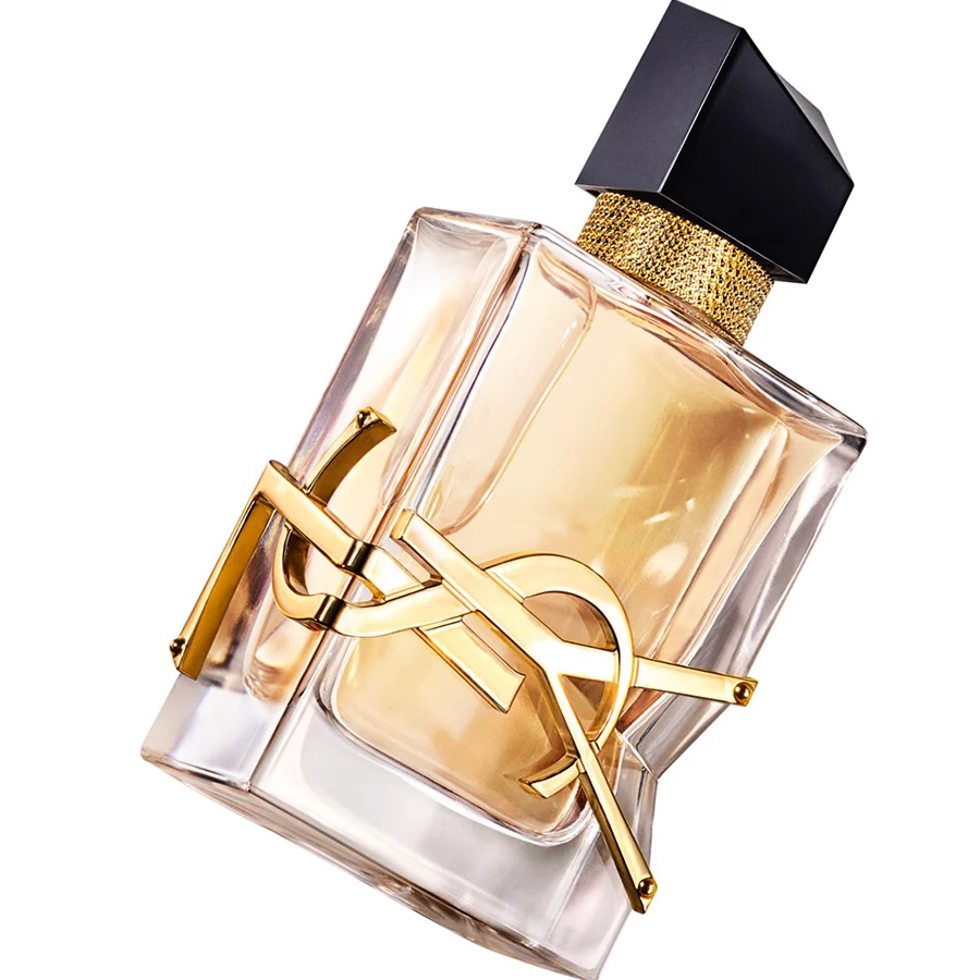 Yves Saint Laurent Libre eau de parfum in a clear glass bottle with pale amber liquid, gold YSL emblem, and black faceted cap.